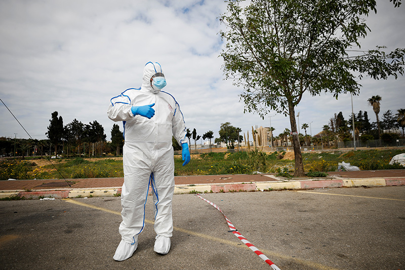 A paramedic wearing a protective suit stands near a special polling station set up by Israel's election committee so Israelis under home-quarantine, such as those who have recently travelled back to Israel from coronavirus hot spots, can vote in Israel's national election, in Ashkelon, Israel, March.