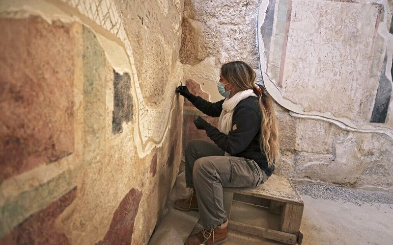 A conservator of the Israel Antiquities Authority restores ancient frescoes at the arches corridor leading to the Herodium palace built by Herod the Great between 23-15 BCE in the Judaean desert, southeast of Bethlehem.