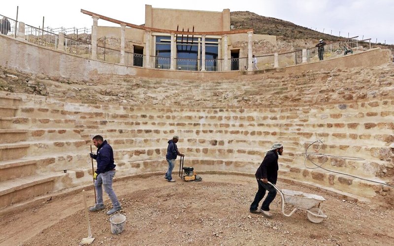 Workers keep flat the restored floor of the ancient theatre built by Herod the Great between 23-15 BCE in the Judaean desert, southeast of Bethlehem in the West Bank, on December 7, 2020.